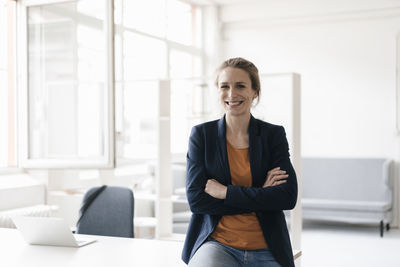 Portrait of smiling businesswoman in a loft