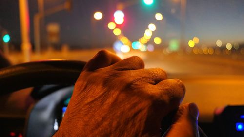 Cropped hand of person driving car