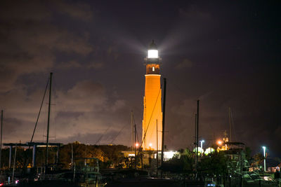 Low angle view of lighthouse against sky at night