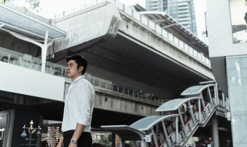 Low angle view of businessman standing in city