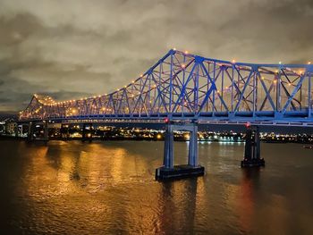 View of bridge over river at night