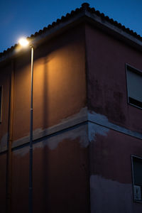 Low angle view of illuminated building against sky