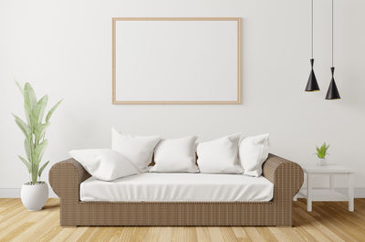 White sofa on table against wall at home