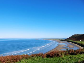 View of seascape against clear blue sky