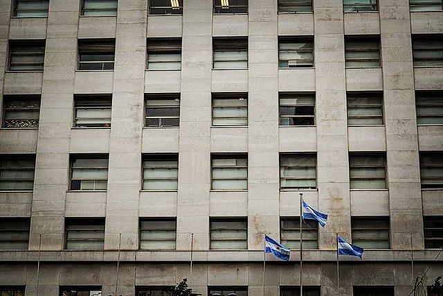 building exterior, architecture, built structure, window, building, low angle view, city, full frame, backgrounds, residential building, glass - material, modern, outdoors, office building, day, reflection, city life, repetition, facade, residential structure