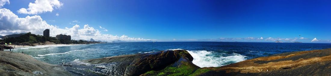 Panoramic view of sea against blue sky