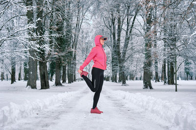 Running woman, girl runner on snow in park winter day. run, sport concept, leisure and freedom.