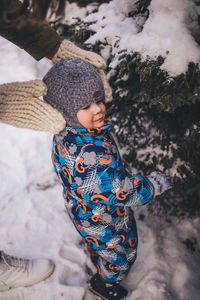 Portrait of smiling baby boy standing on snow