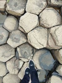 Low section of person standing on cobblestone