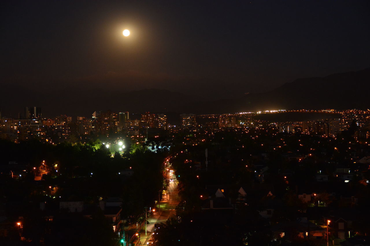 ILLUMINATED CITYSCAPE AT NIGHT