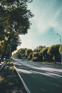 Road amidst trees against sky