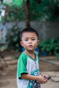 Portrait of cute boy standing outdoors