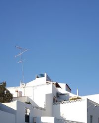 Low angle view of buildings against clear blue sky