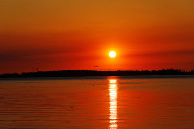 Scenic view of lake against sky during sunset
