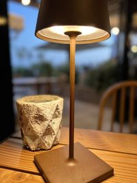 Close-up of illuminated lamp on table