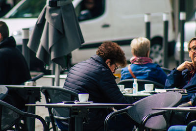 Rear view of people sitting on chair