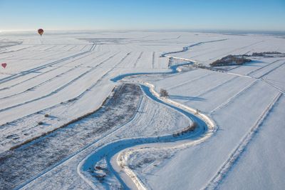 Aerial view of snow covered land