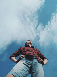 Low angle view of man standing against sky