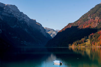 Scenic view of lake and mountains against sky