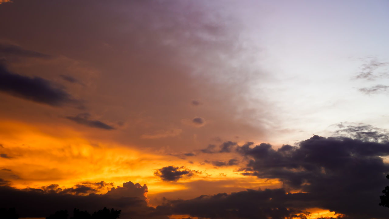 sky, cloud, sunset, beauty in nature, scenics - nature, dramatic sky, afterglow, environment, nature, tranquility, silhouette, tree, orange color, red sky at morning, tranquil scene, cloudscape, idyllic, landscape, no people, sunlight, evening, atmospheric mood, outdoors, multi colored, sun, plant, dawn, awe, moody sky, vibrant color, yellow, twilight, land, non-urban scene, sunbeam, storm, overcast, backgrounds, horizon, back lit, light - natural phenomenon, travel destinations, low angle view, travel, red, copy space, dark