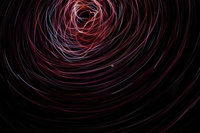 Low angle view of light painting against sky at night