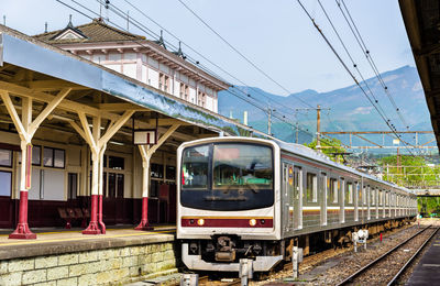 Train at railroad station against sky