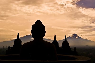 Silhouette of temple against sky during sunset