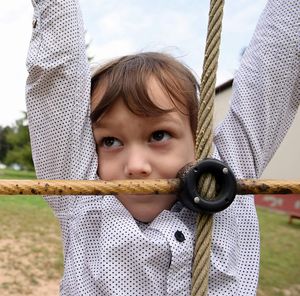 Portrait of cute boy holding rope