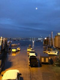 Boats moored in sea against sky at night