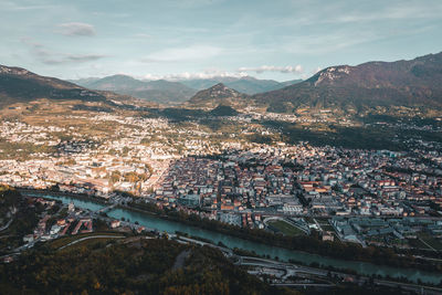 High angle view of townscape by river against sky