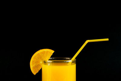 Yellow drink against black background