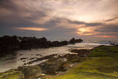 Scenic view of beach against sky during sunset