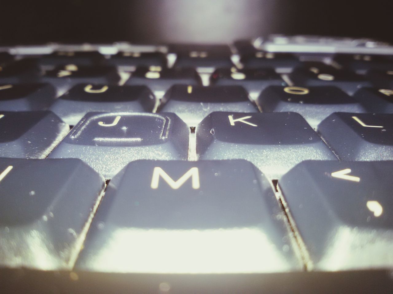 CLOSE-UP OF COMPUTER KEYBOARD AT HOME