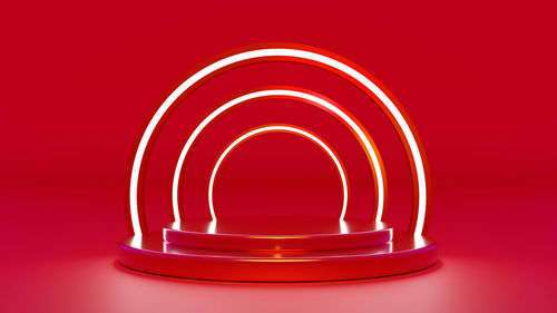 Close-up of lit candle against red background