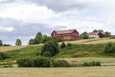 Houses on field against sky