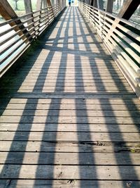 Shadow of railing on footpath