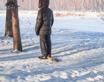 Full length of man standing on snow covered land