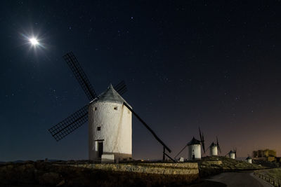 Low angle view of windmill against sky at night