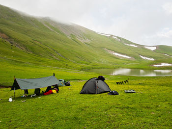 Scenic view of tent on mountain against sky