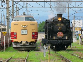 Train on railroad track against sky