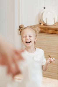 Portrait of smiling girl playing with toys on table