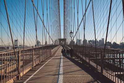 People walking on brooklyn bridge in city