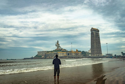 Man praying at murdeshwar temple early morning view from unique angle