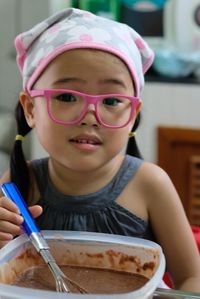 Close-up of cute girl preparing food on table