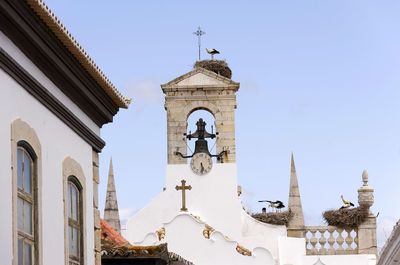 High section of bell tower against clear sky