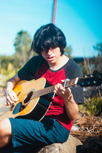 Full length of a man playing guitar