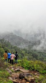 People on landscape against mountains