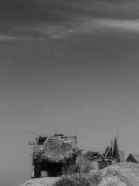 Abandoned house on field against sky