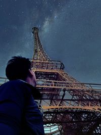 Low angle view of man tower against sky at night