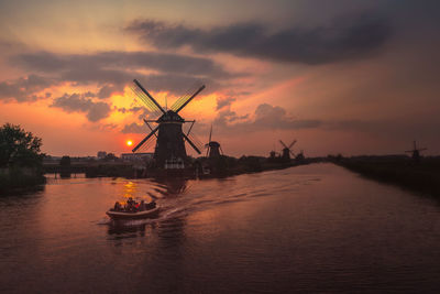 Scenic view of nautical vessel against sky during sunset